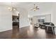 Cozy living room open to the kitchen, showcasing dark hardwood floors and stainless steel appliances at 1801 Heirloom Dr., Conway, SC 29527