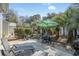 Backyard patio featuring a lounge chairs, seating with umbrella and a garden with palm trees at 182 Minnow Dr., Pawleys Island, SC 29585