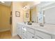 Bright bathroom with double sinks, white cabinets, and a large mirror reflecting the space at 182 Minnow Dr., Pawleys Island, SC 29585