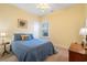 Comfortable bedroom with a ceiling fan, side table lamp and attractive blue bedspread at 182 Minnow Dr., Pawleys Island, SC 29585