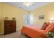 Comfortable bedroom with a ceiling fan, side table lamp and attractive orange bedspread at 182 Minnow Dr., Pawleys Island, SC 29585