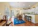 Bright dining room with wood floors, chandelier, and bar stool seating at counter at 182 Minnow Dr., Pawleys Island, SC 29585