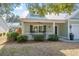 A cozy front porch with rocking chairs, a ceiling fan, and views of the surrounding neighborhood at 182 Minnow Dr., Pawleys Island, SC 29585