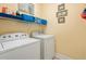 Bright laundry room with a white washer and dryer and shelves for organizing supplies at 182 Minnow Dr., Pawleys Island, SC 29585