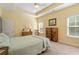 Bright primary bedroom with a tray ceiling, natural light, rocking chair, and dresser at 182 Minnow Dr., Pawleys Island, SC 29585