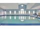 Bright and airy indoor pool area with blue accents and large arched windows at 1989 Wild Indigo Circle Nw # 9, Calabash, NC 28467