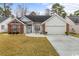 Charming single-story home with a well-manicured lawn and a brick-accented facade at 199 Glenwood Dr., Conway, SC 29526