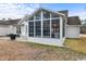 A large screened porch with a high ceiling offering a peaceful outdoor living space at 199 Glenwood Dr., Conway, SC 29526