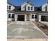 New two-story townhome featuring an attached garage and a concrete driveway, ready for its new owners at 2034 Wild Indigo Circle Nw # 206, Calabash, NC 28467