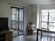 Bright living room with sliding glass doors to a balcony and hardwood floors at 207 Indian Wells Ct. # 207, Murrells Inlet, SC 29576