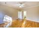 Bedroom with hardwood floors, ceiling fan, and open doorway to bathroom at 221 Hagley Dr., Pawleys Island, SC 29585