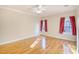 Light-filled bedroom featuring hardwood floors, neutral paint, two bright windows, and a ceiling fan at 221 Hagley Dr., Pawleys Island, SC 29585