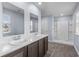 Bathroom features a double sink vanity, a walk-in shower, and a window with natural light at 224 Pine Forest Dr., Conway, SC 29526