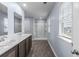 Bathroom features a double sink vanity, a walk-in shower, and a window with exterior view at 224 Pine Forest Dr., Conway, SC 29526