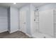 Bright bathroom featuring a walk-in shower, closet shelving, and stylish tile flooring at 224 Pine Forest Dr., Conway, SC 29526