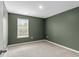 Bedroom featuring carpeted floors, light green walls, and a window with blinds at 224 Pine Forest Dr., Conway, SC 29526