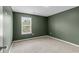 Empty bedroom with carpet, neutral trim, green walls and a window at 224 Pine Forest Dr., Conway, SC 29526