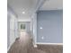 Light-filled hallway features light blue walls and wood-look floors, leading to a bright room with sliding glass doors at 224 Pine Forest Dr., Conway, SC 29526