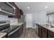 Functional kitchen featuring stainless steel appliances, dark wood cabinets, and a convenient layout at 224 Pine Forest Dr., Conway, SC 29526