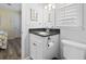 Bathroom with dark granite counters, white cabinets, and a toilet at 300 Oak Lake Circle, North Myrtle Beach, SC 29582