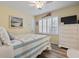 Cozy bedroom with light yellow walls, white furniture, and shuttered windows at 300 Oak Lake Circle, North Myrtle Beach, SC 29582