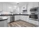 Modern kitchen featuring white cabinetry, stainless steel appliances, and sleek countertops at 300 Oak Lake Circle, North Myrtle Beach, SC 29582