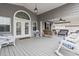 Cozy porch featuring an arched door, a swing, and comfortable wicker chairs at 300 Oak Lake Circle, North Myrtle Beach, SC 29582