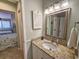 Bathroom with a granite countertop and a decorative mirror next to the entrance of a bedroom at 301 Myrtlewood Ct. # 17-E, Myrtle Beach, SC 29572