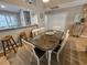 Dining area adjacent to the kitchen features a large table, seating for six, and sliding glass door at 301 Myrtlewood Ct. # 17-E, Myrtle Beach, SC 29572