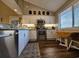 Bright kitchen showcasing white cabinetry, granite countertops, and stainless steel appliances at 301 Myrtlewood Ct. # 17-E, Myrtle Beach, SC 29572