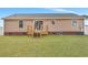 Exterior of home features a wood deck and a large yard with mature lawn at 308 Stone Throw Dr., Murrells Inlet, SC 29576