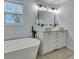 Bright bathroom featuring double vessel sinks, a soaking tub, and modern fixtures at 308 Stone Throw Dr., Murrells Inlet, SC 29576