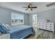 Serene bedroom featuring a ceiling fan, large window, and view into ensuite bathroom at 308 Stone Throw Dr., Murrells Inlet, SC 29576