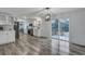 Bright kitchen featuring stainless steel appliances, white cabinetry, and a sliding glass door to the deck at 308 Stone Throw Dr., Murrells Inlet, SC 29576