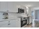 Modern kitchen features stainless steel appliances, white cabinetry, and beautiful countertops at 308 Stone Throw Dr., Murrells Inlet, SC 29576