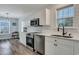 Modern kitchen with stainless steel appliances, crisp white cabinets, and contemporary fixtures and finishes at 308 Stone Throw Dr., Murrells Inlet, SC 29576