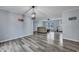 Open-concept living space featuring light blue walls, wood-look flooring, and modern lighting fixtures at 308 Stone Throw Dr., Murrells Inlet, SC 29576