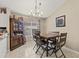 Cozy dining area featuring a wooden table, six chairs, a chandelier, and an adjacent hutch at 3103 Robyn Ct., Little River, SC 29566