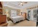 Spacious main bedroom featuring a tray ceiling, carpet, and a view of the backyard at 3103 Robyn Ct., Little River, SC 29566