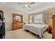 Cozy main bedroom featuring a tray ceiling, neutral paint, carpet, and a large dresser at 3103 Robyn Ct., Little River, SC 29566