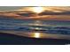 Scenic beach view with ocean waves and a sunset casting beautiful reflections on the wet sand at 3127 Tiger Tail Rd., Conway, SC 29526