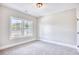 Cozy bedroom with plush carpet and a large window offering neighborhood views at 3127 Tiger Tail Rd., Conway, SC 29526