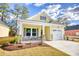 Inviting one-story home featuring stone accents, tidy landscaping, and a convenient attached garage at 3127 Tiger Tail Rd., Conway, SC 29526