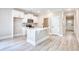 Well-lit kitchen with white cabinets, stainless steel appliances, and center island with seating at 3127 Tiger Tail Rd., Conway, SC 29526