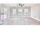 Bright living room with luxury vinyl plank floors, ceiling fan, and natural light from sliding glass door at 3127 Tiger Tail Rd., Conway, SC 29526