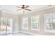 Bright living room with luxury vinyl plank floors, ceiling fan, and natural light from sliding glass door at 3127 Tiger Tail Rd., Conway, SC 29526