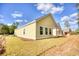 Back exterior of a home with bright yellow siding and a covered patio at 3127 Tiger Tail Rd., Conway, SC 29526