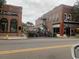 Exterior view of a street with shops and cafes, featuring outdoor seating and string lights at 3127 Tiger Tail Rd., Conway, SC 29526