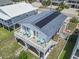 Aerial shot of a charming home with a large deck, solar panels, and neatly manicured lawn in a coastal setting at 315 60Th Ave. N, North Myrtle Beach, SC 29582