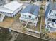 Charming coastal home with a spacious deck, solar panels, and a fenced yard situated along a waterway at 315 60Th Ave. N, North Myrtle Beach, SC 29582
